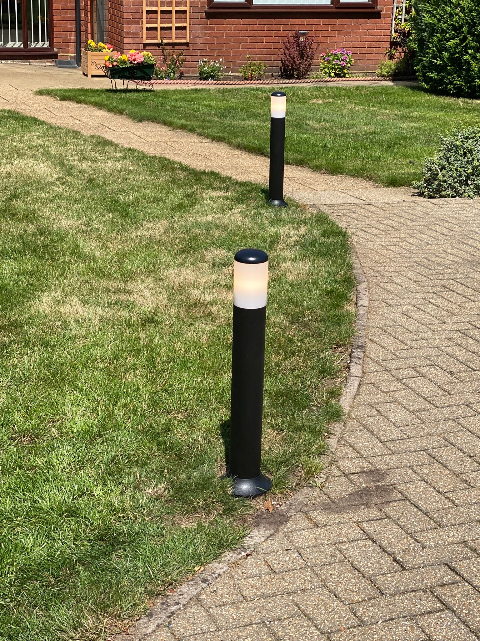 Outdoor garden lighting installation along a pathway in Suffolk