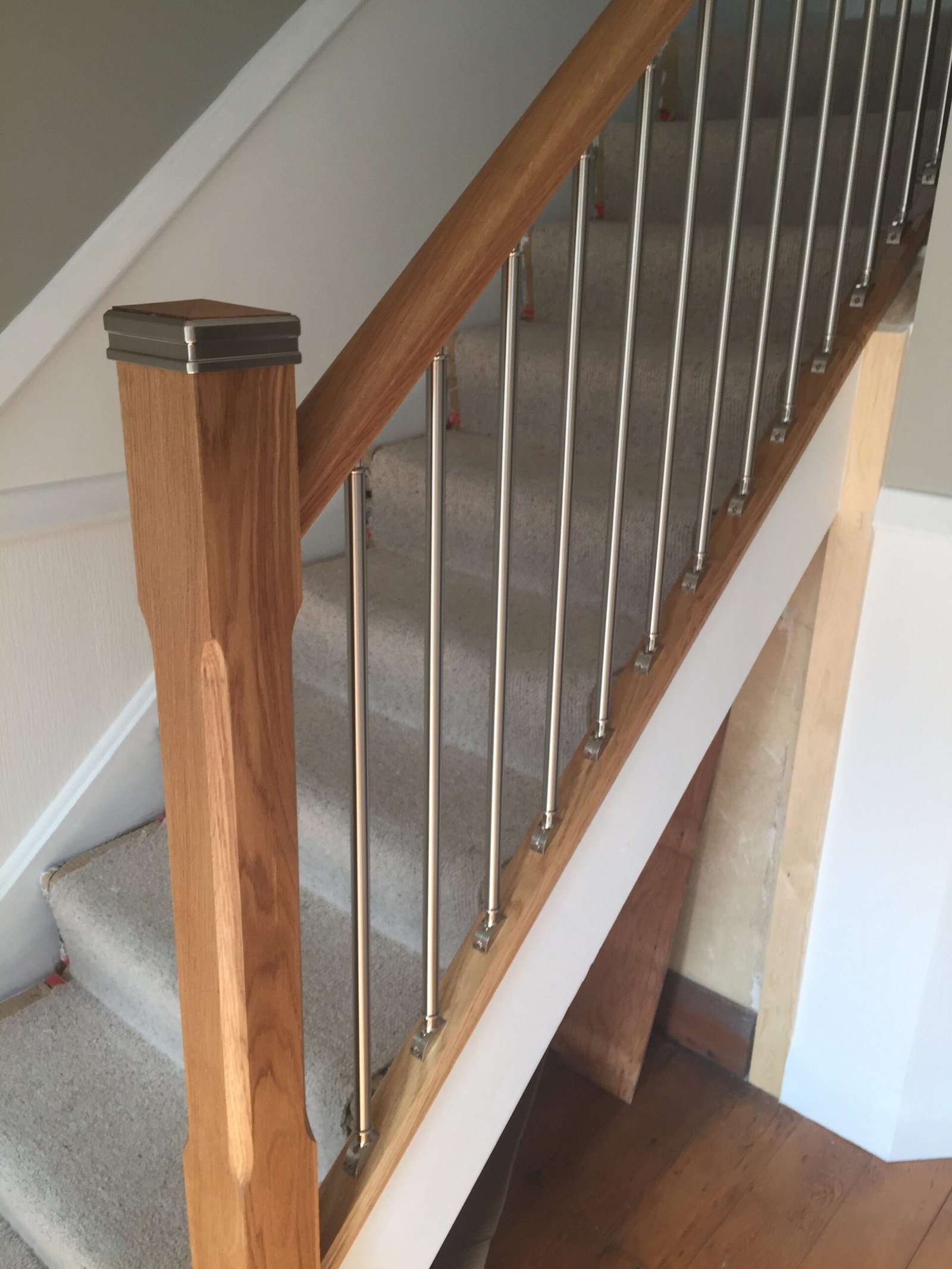 Stair refurbishment with oak handrail and stainless steel spindles in Ipswich